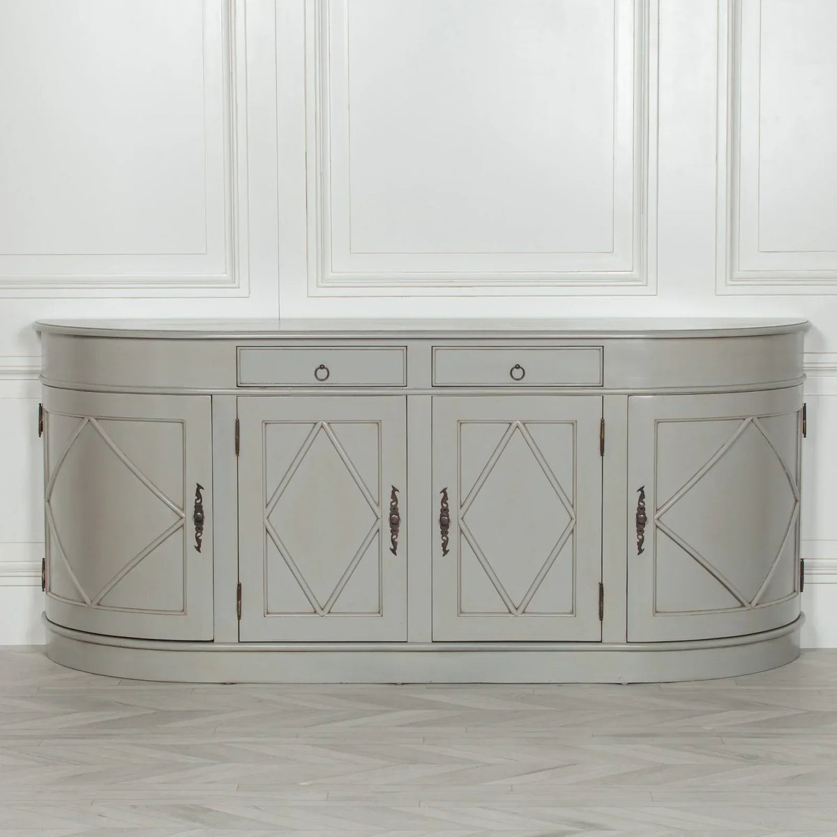 Grey sideboard cabinet with diamond panel doors and curved edges against white wall