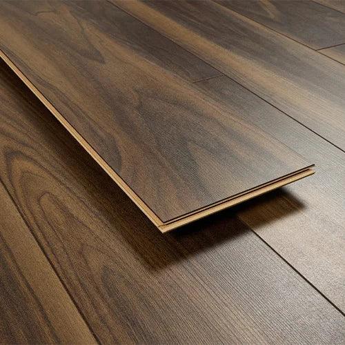 Dark walnut laminate flooring plank with realistic wood grain design on smooth surface