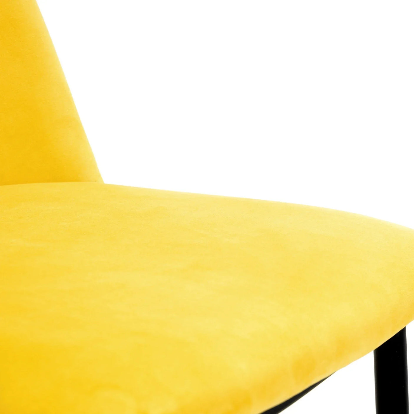 Close-up of mustard yellow chair seat with soft upholstery and black legs