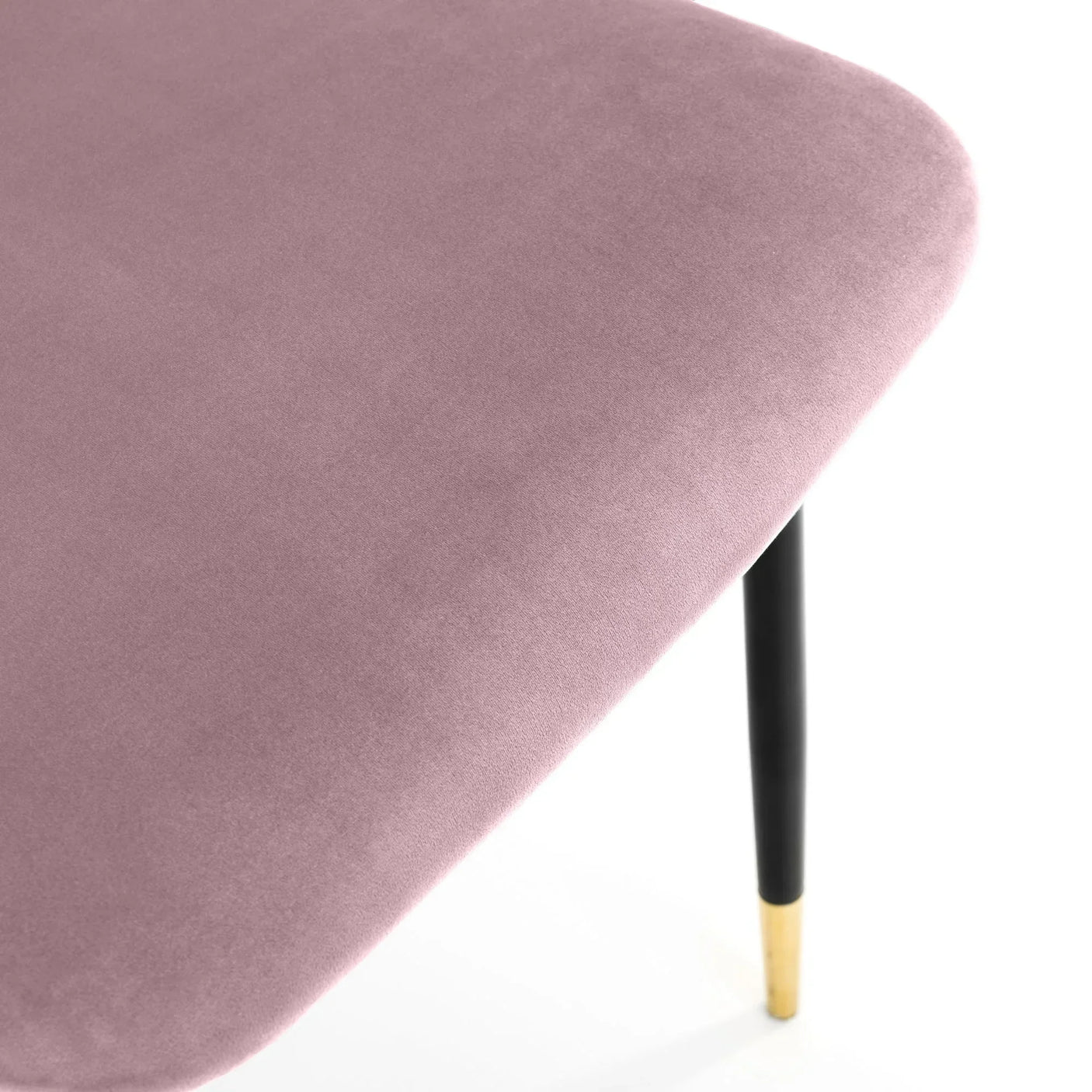Pink chair seat detail with soft velvet fabric and black leg featuring gold tip
