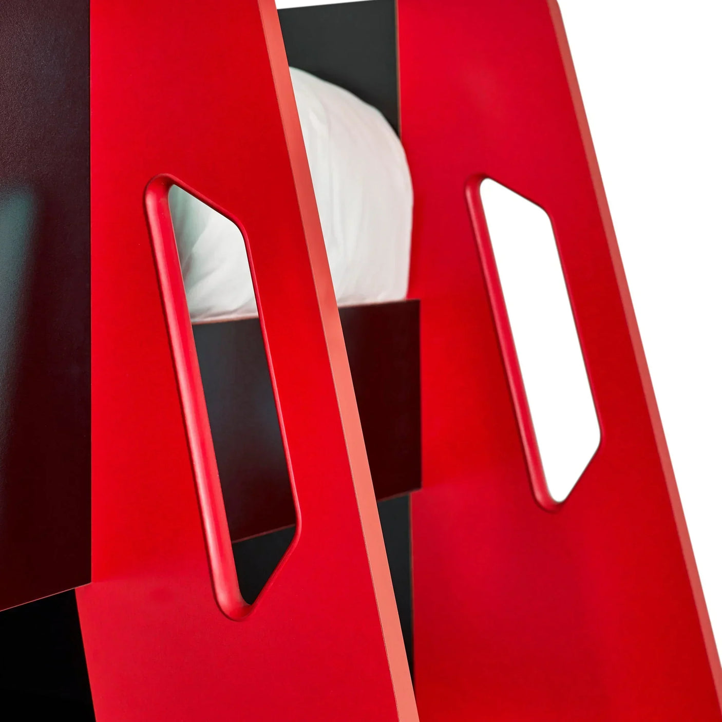 Red bunk bed ladder with cut-out handles and white bedding visible behind