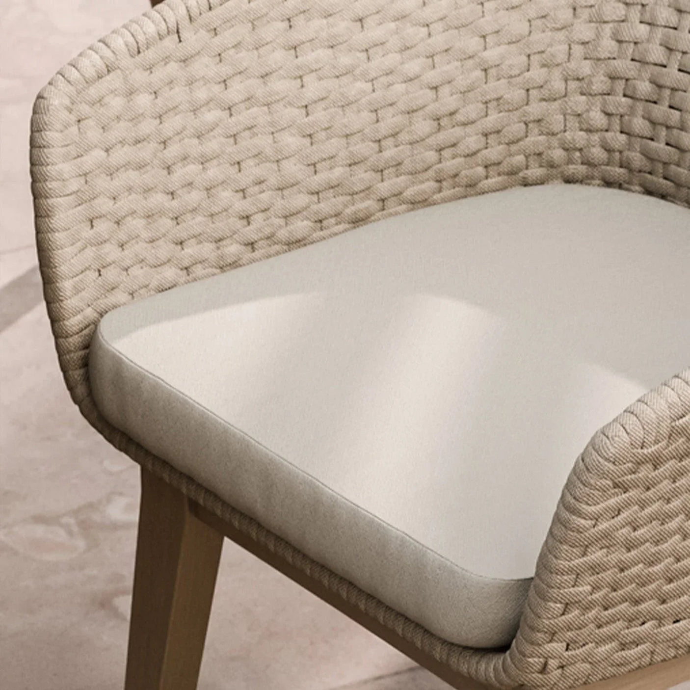 Beige woven rattan dining chair with cushioned seat and wooden legs