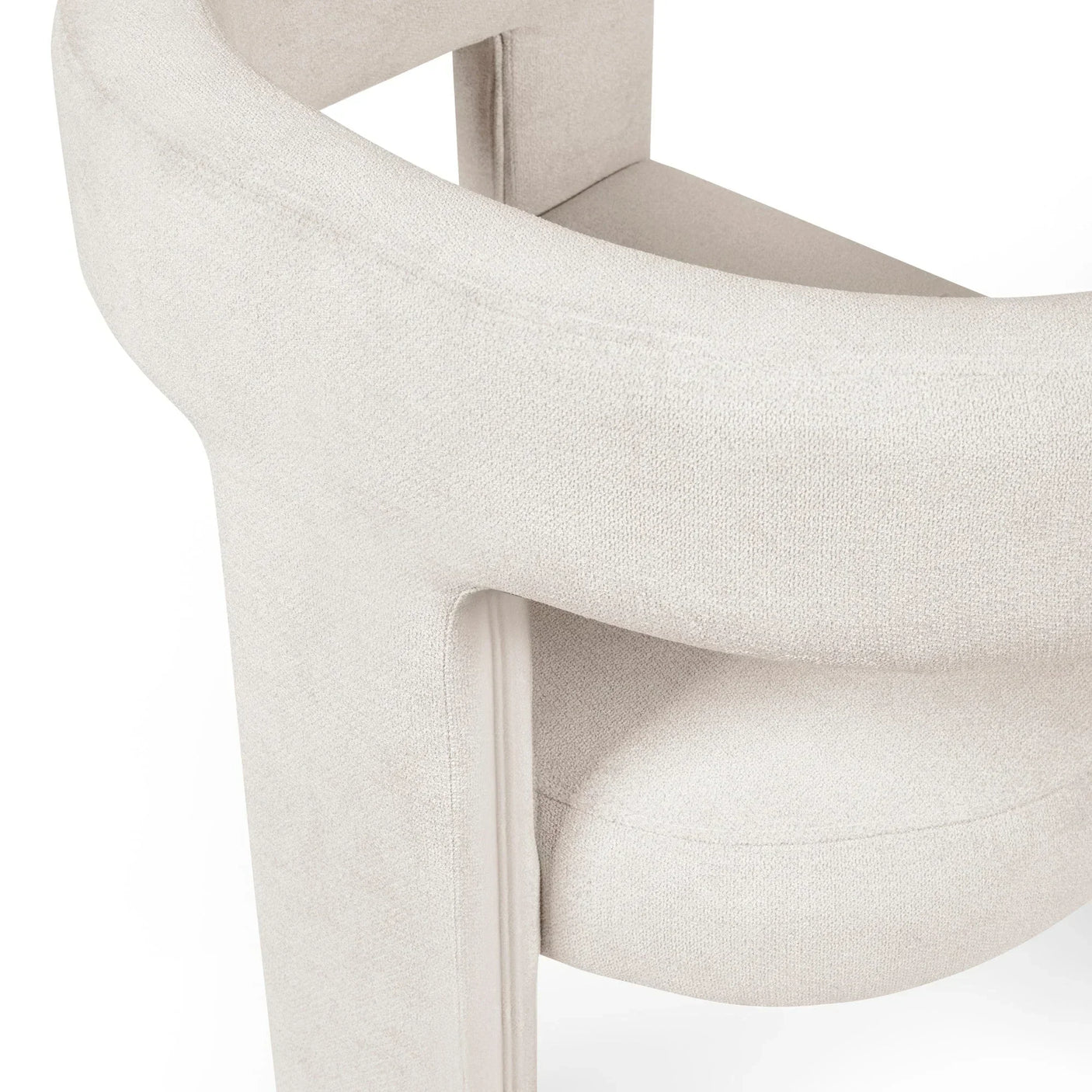 Close detail of modern cream fabric armchair with curved backrest and padded seat