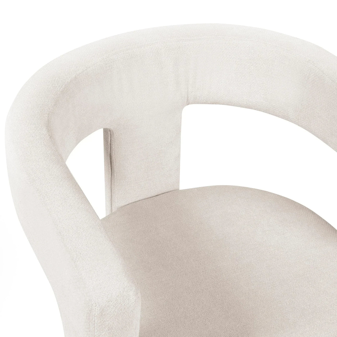 Close-up of cream upholstered accent chair with curved backrest and soft fabric seat