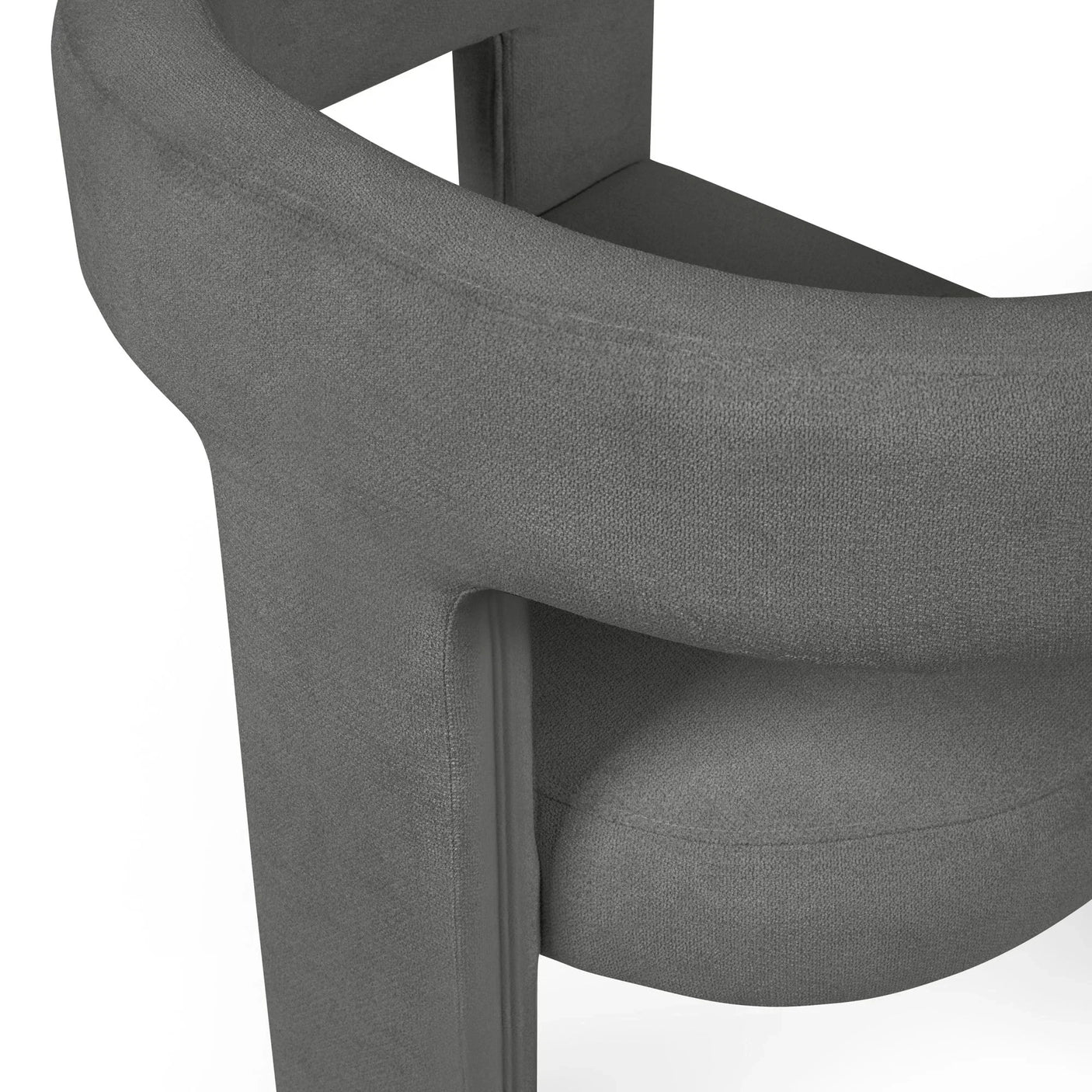 Close-up of modern grey fabric armchair with rounded backrest and cushioned seat