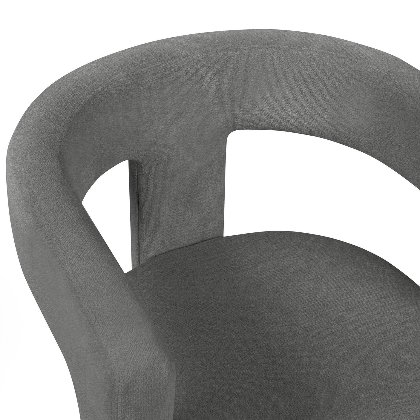 Curved grey velvet armchair with open back detail, close-up of seat and armrest