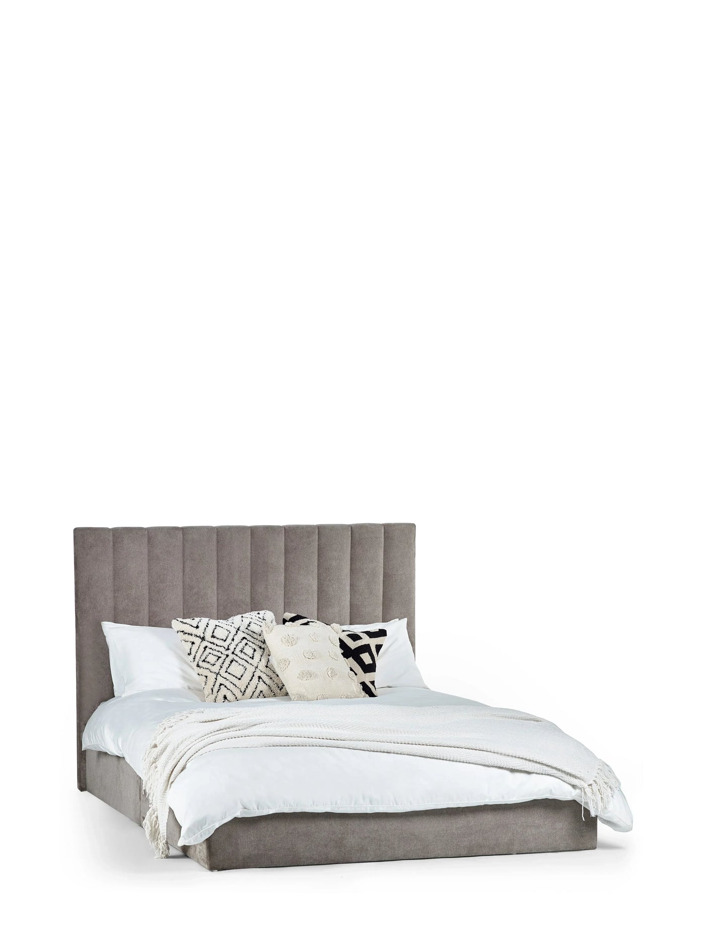 Grey upholstered double bed with vertical panel headboard, white bedding and patterned cushions