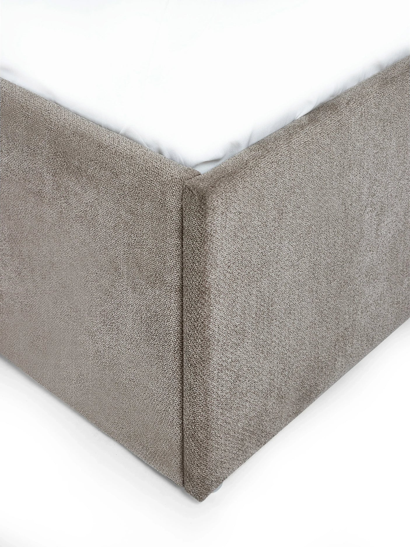 Close up of grey upholstered double bed frame corner with fabric texture