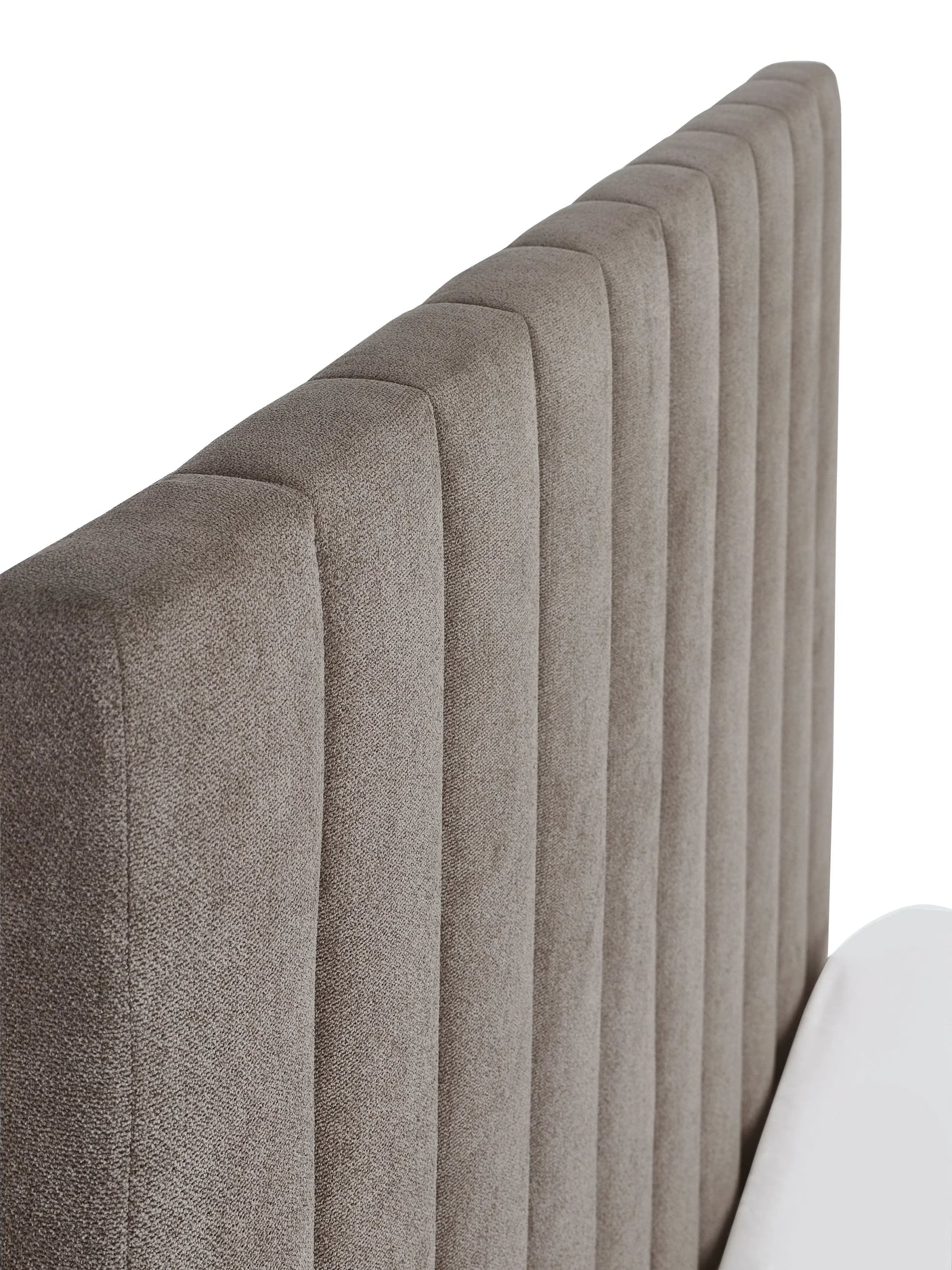 Grey upholstered bed headboard with vertical channel stitching, close-up angle