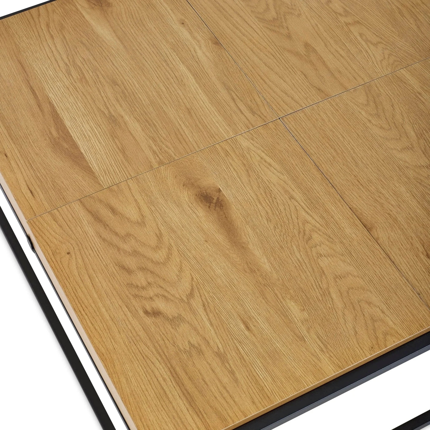 Closeup of oak effect dining table top with black frame showing wood grain and panel lines