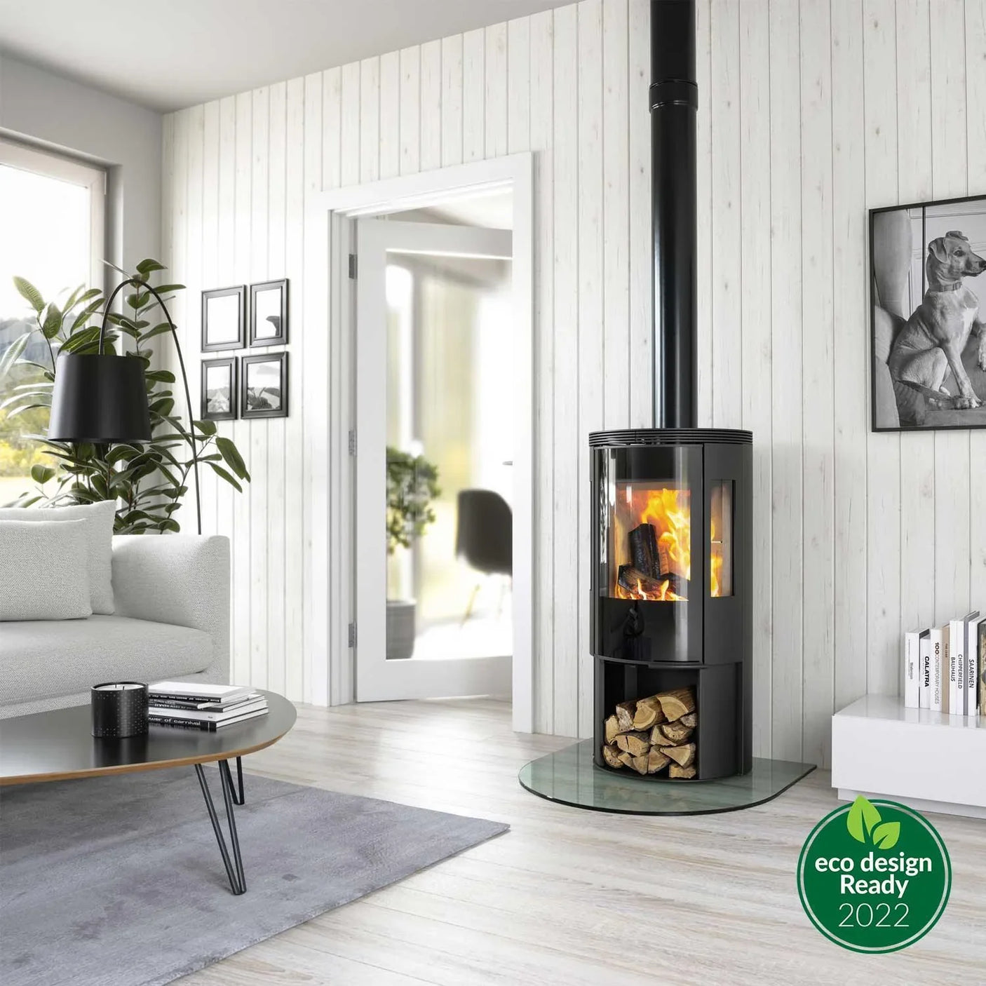 Black wood burning stove with glass door, logs stored below in modern living room