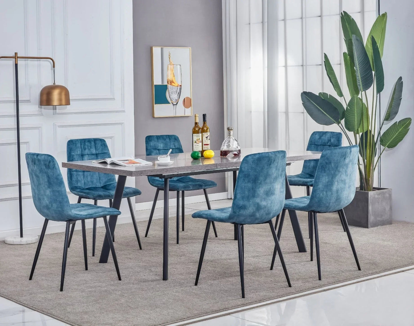 Marble dining table with black legs and six blue velvet chairs in modern dining room