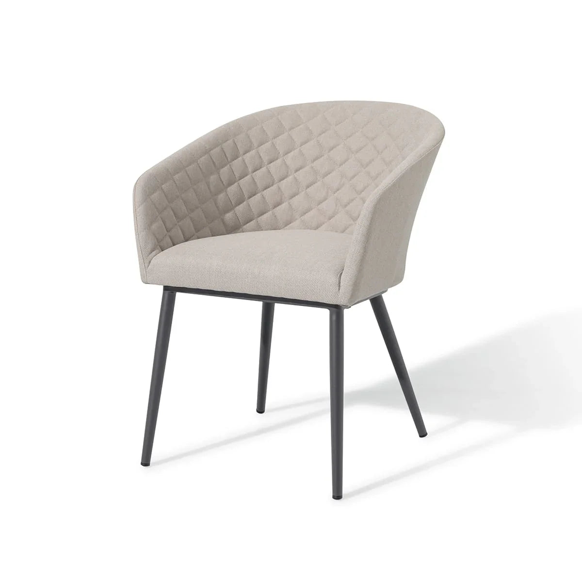 Beige fabric dining chair with quilted backrest and black metal legs on white background