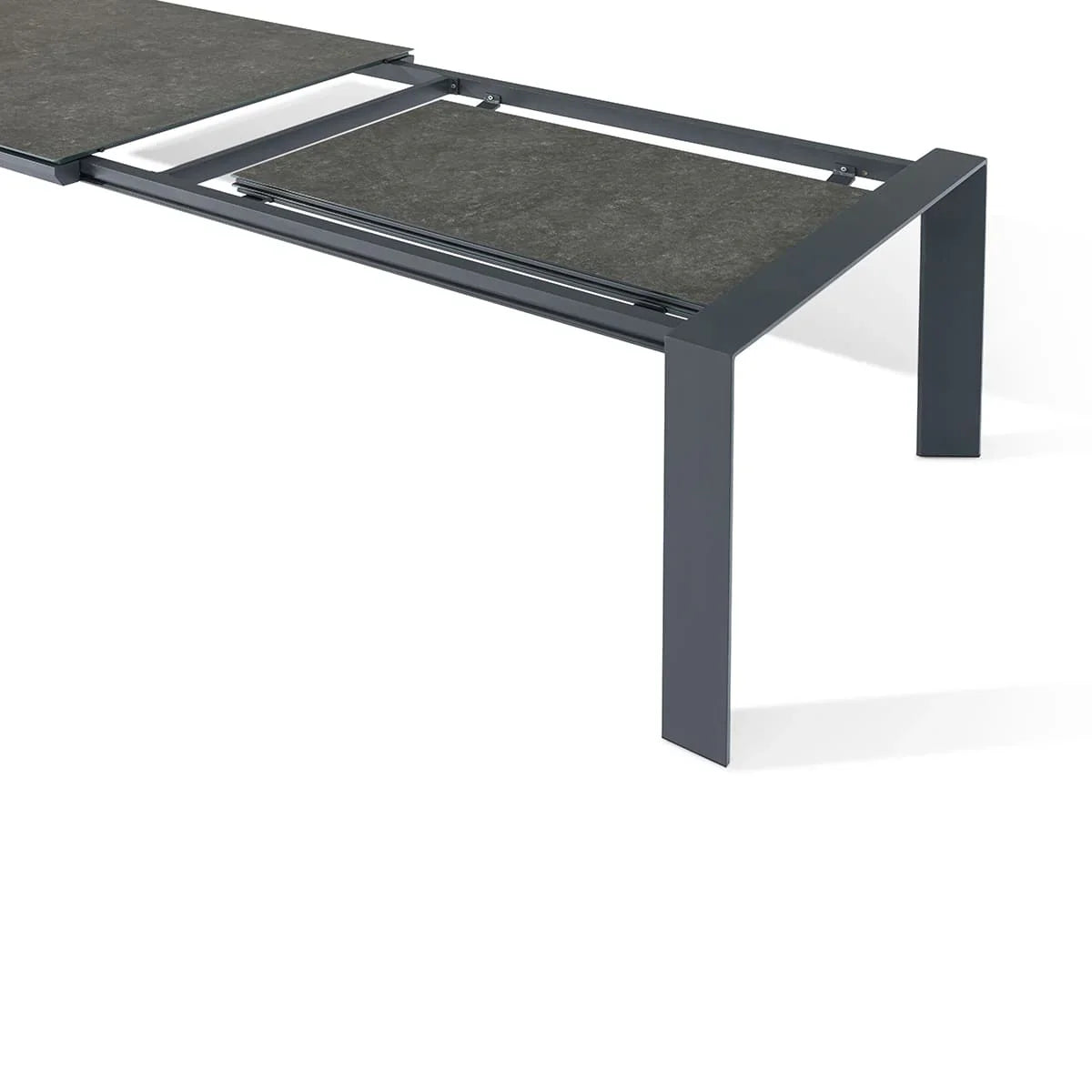 Grey outdoor extending dining table with ceramic top and metal frame shown partially open