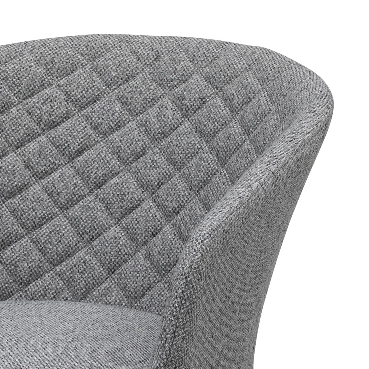 Closeup of grey fabric armchair with quilted backrest upholstery