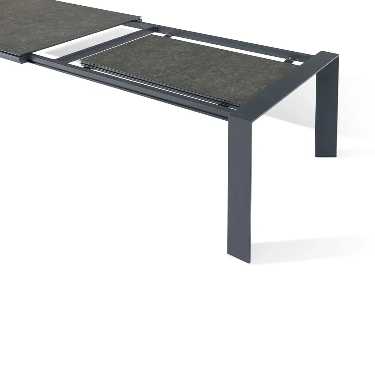 Dark grey extending dining table with ceramic top and metal frame, corner angle view