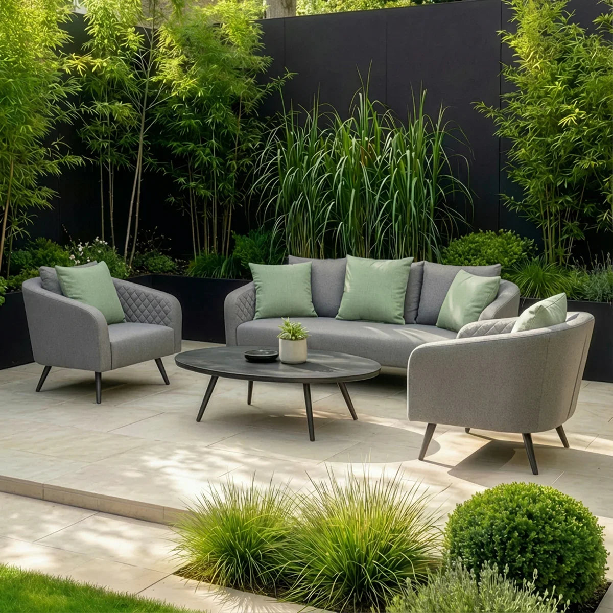Grey outdoor sofa set with green cushions and black coffee table on patio