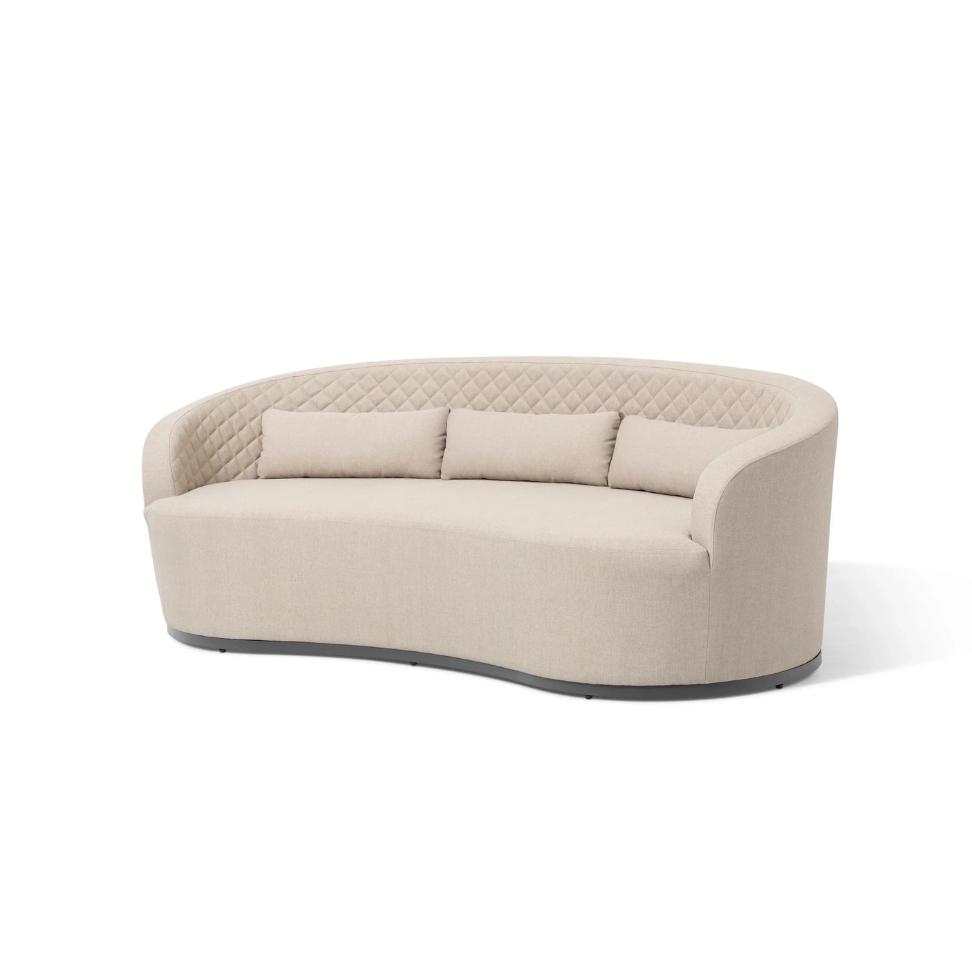 Curved beige fabric sofa with quilted backrest and three matching cushions on white background