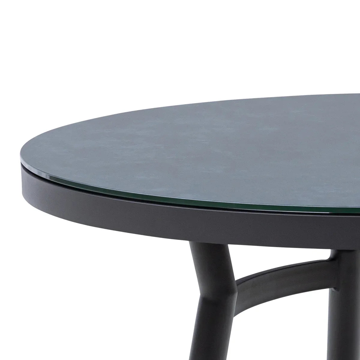 Round black glass dining table with metal legs, close-up of table edge and surface