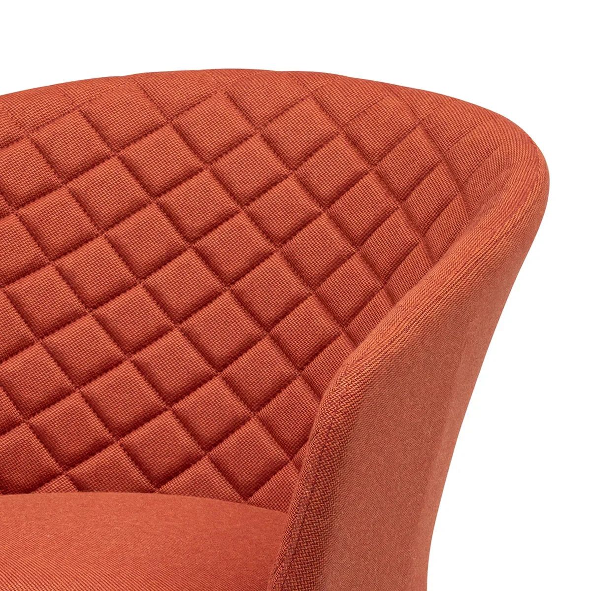 Close up of orange fabric dining chair with quilted diamond pattern on backrest