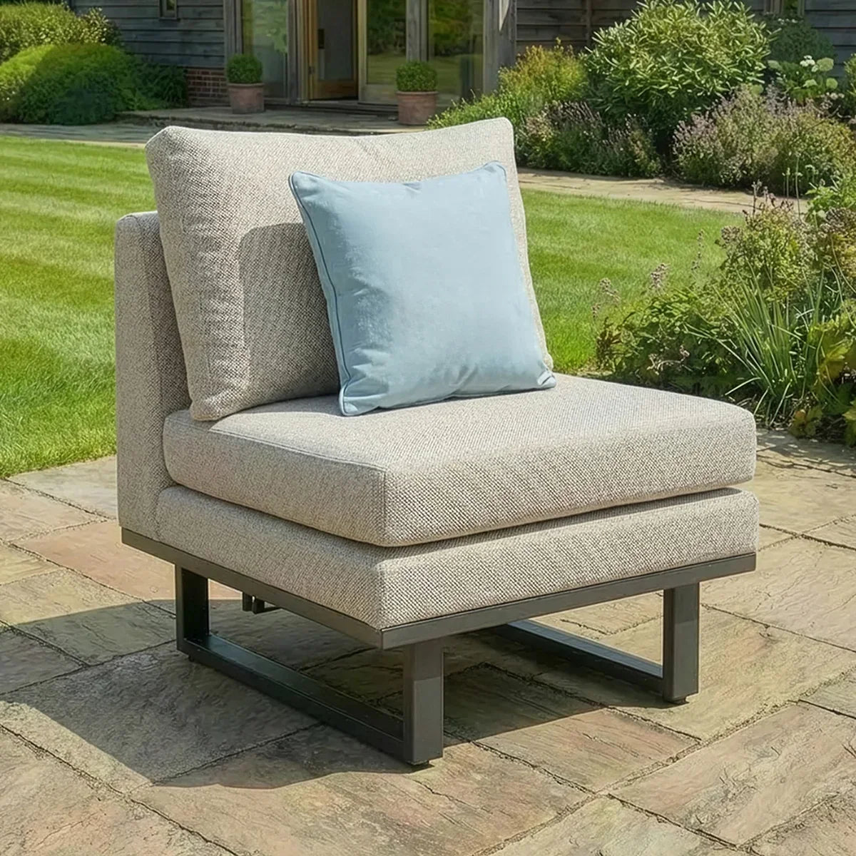 Outdoor fabric lounge chair with metal frame and blue cushion on patio