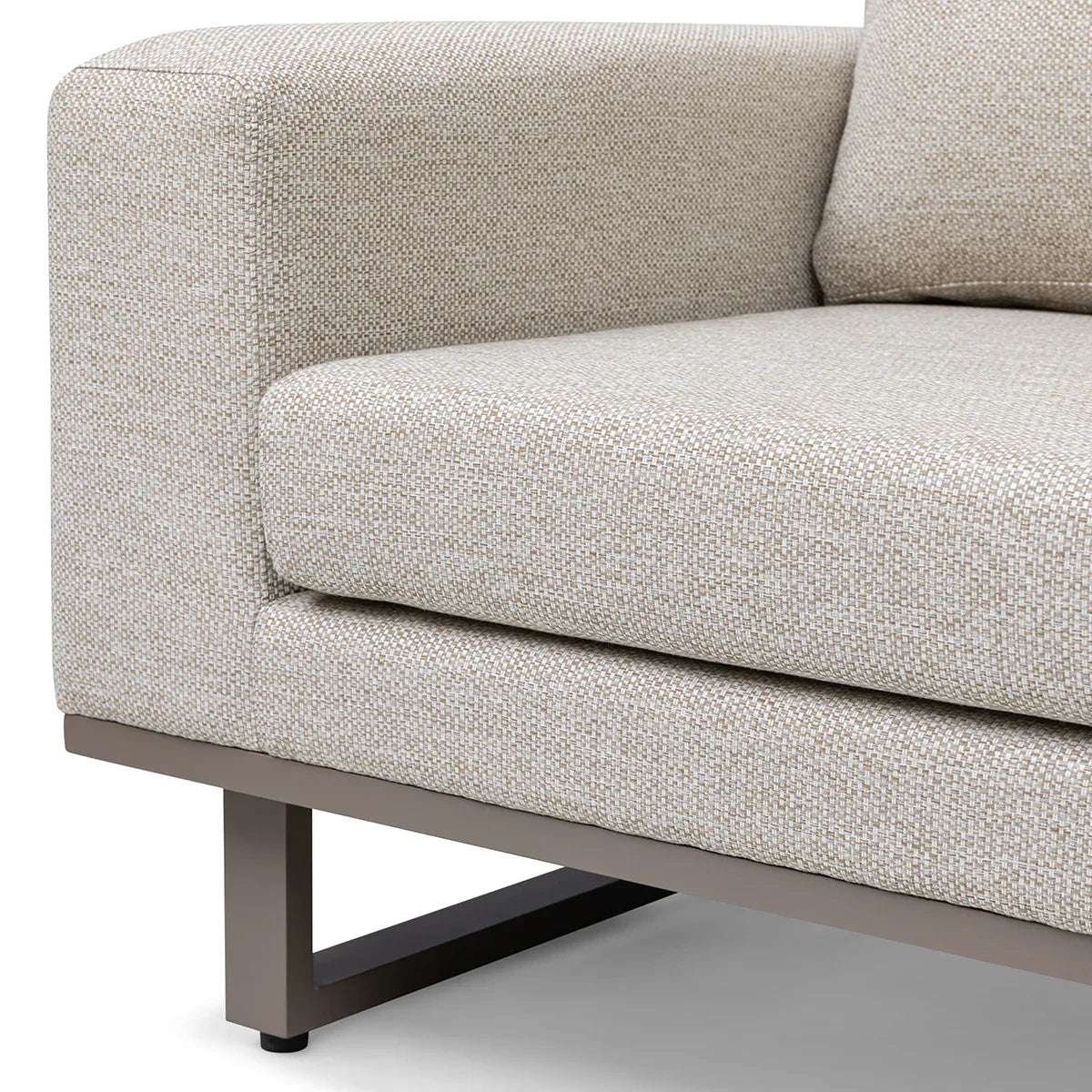 Corner view of beige fabric sofa with metal legs and square armrest