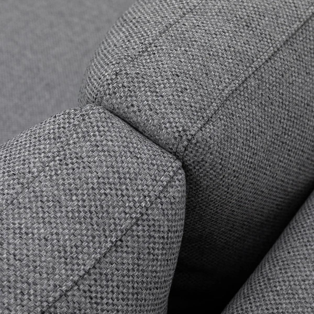 Closeup of grey fabric sofa arm with textured upholstery and stitching detail