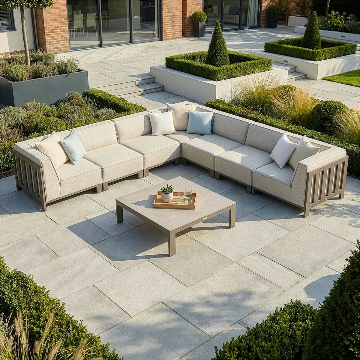 Beige outdoor corner sofa set with cushions and coffee table on modern patio