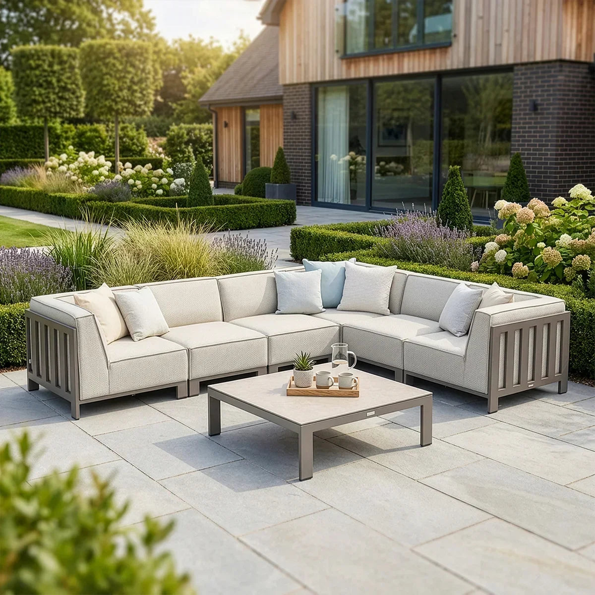 Outdoor corner garden sofa set with grey cushions and coffee table on patio