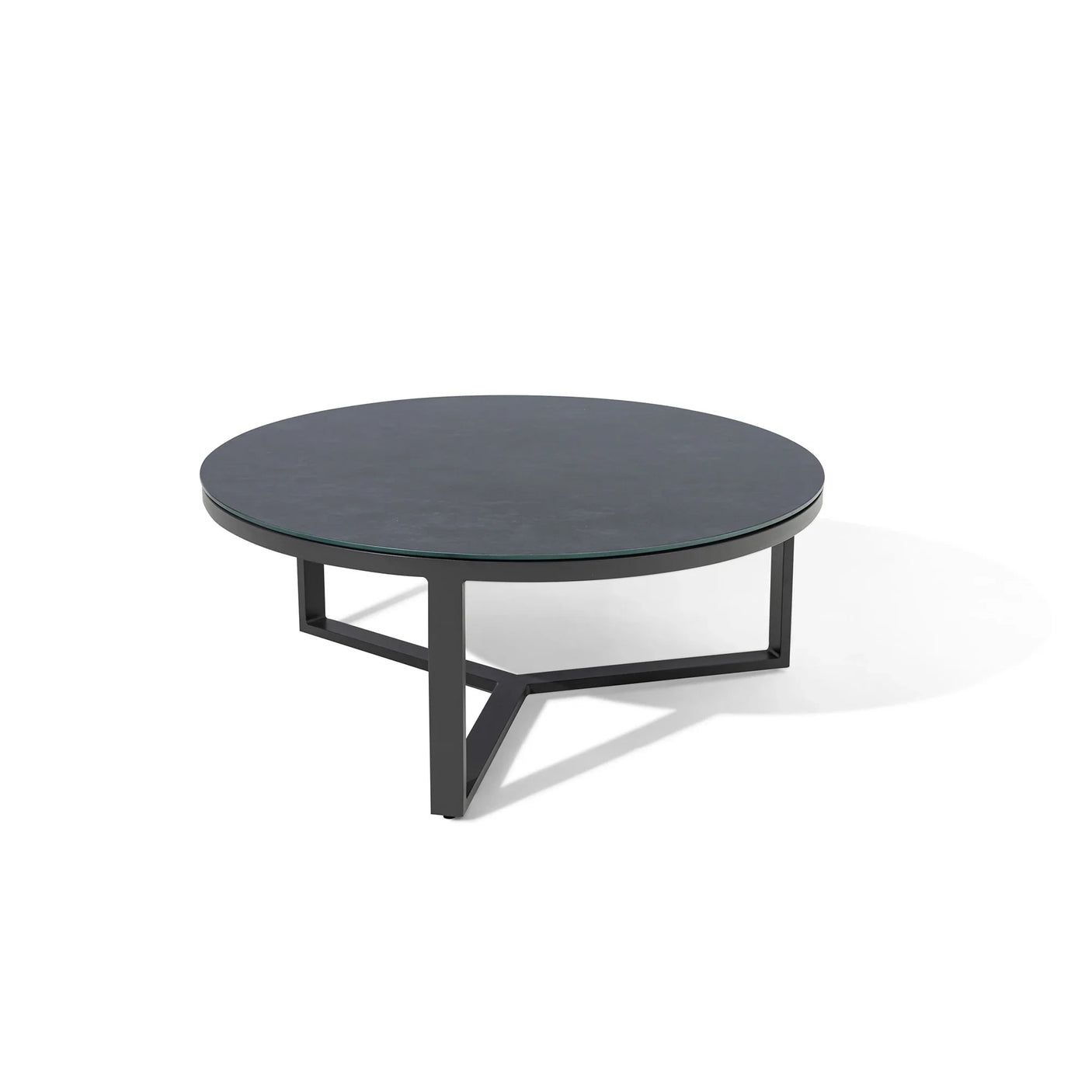 Round black coffee table with glass top and metal base on white background