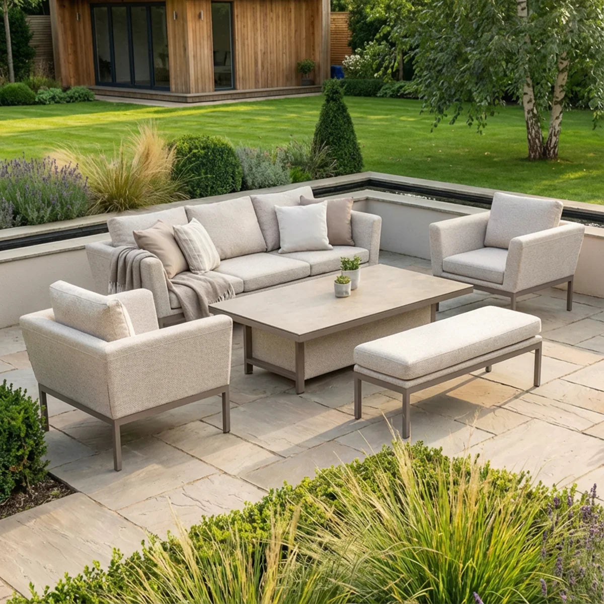 Modern outdoor furniture set with beige sofa, armchairs and coffee table on stone patio