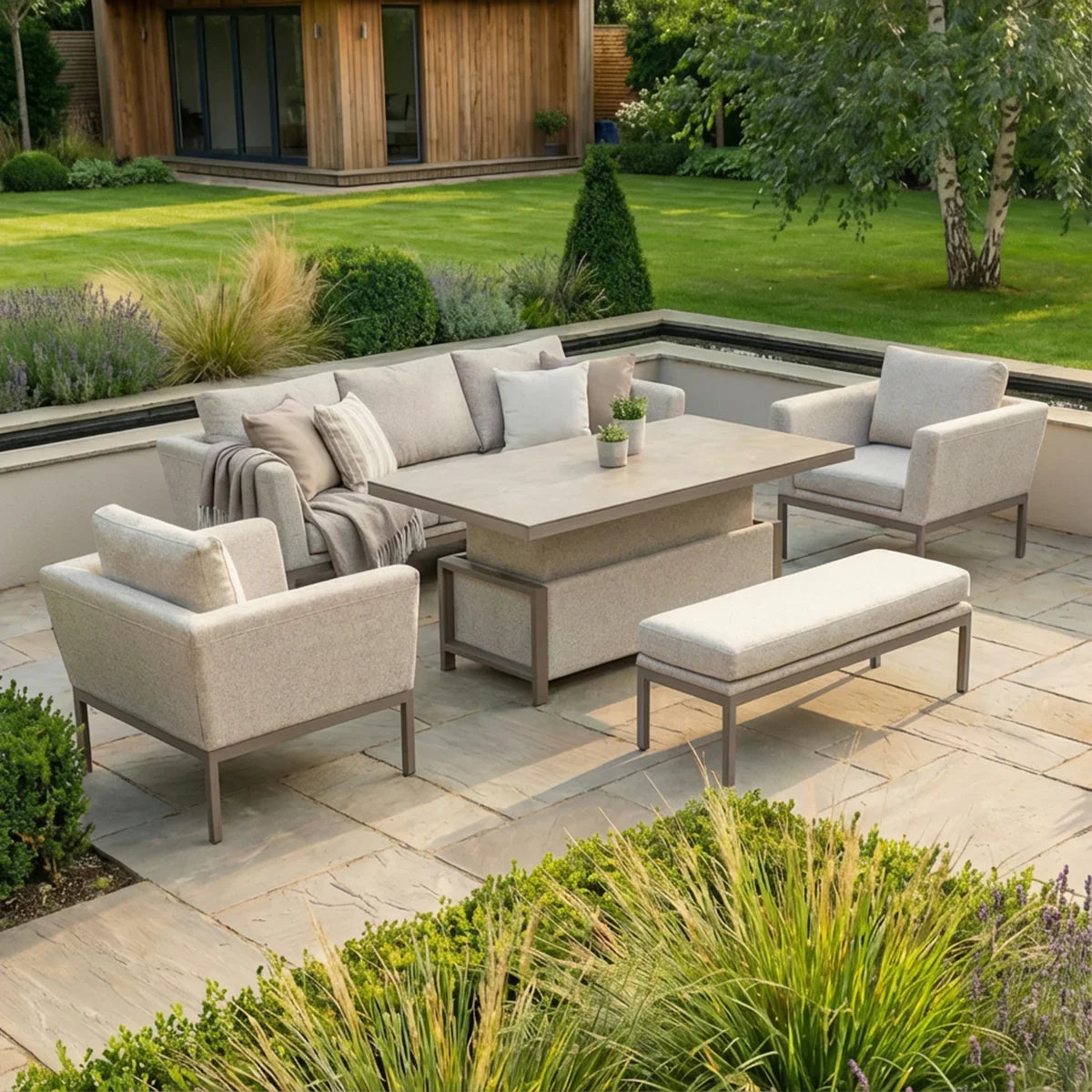 Modern outdoor garden furniture set with grey sofa, armchairs, dining table, and bench