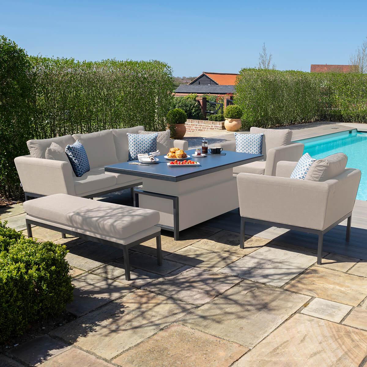 Beige outdoor corner sofa set with cushions and dining table beside pool on patio