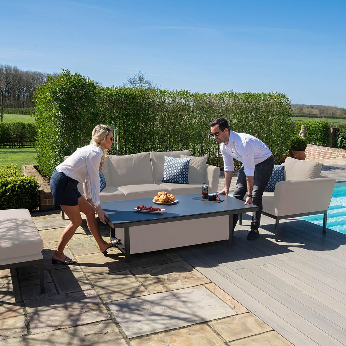 Outdoor patio sofa set with adjustable table beside pool on stone terrace