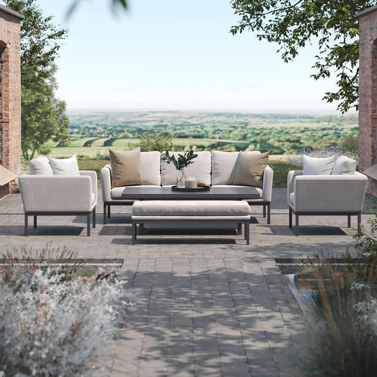 Modern outdoor sofa set with cream cushions and coffee table on stone patio