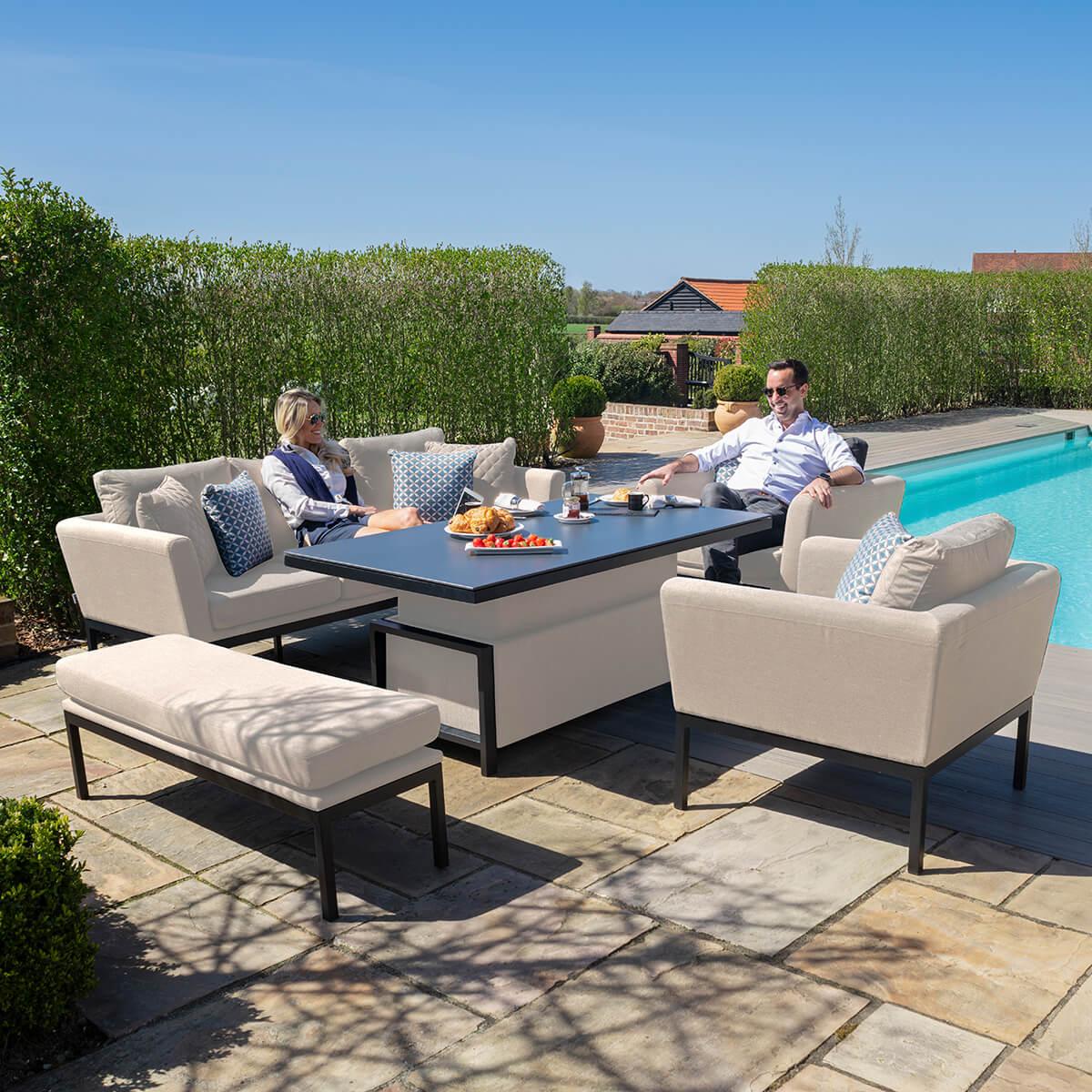 Cream outdoor sofa dining set with cushions and bench by poolside patio