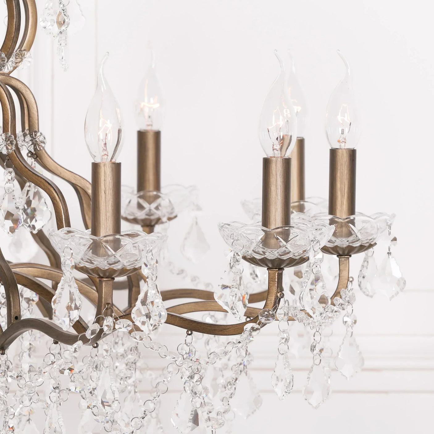 Antique brass chandelier with glass crystal drops and candle-style lights