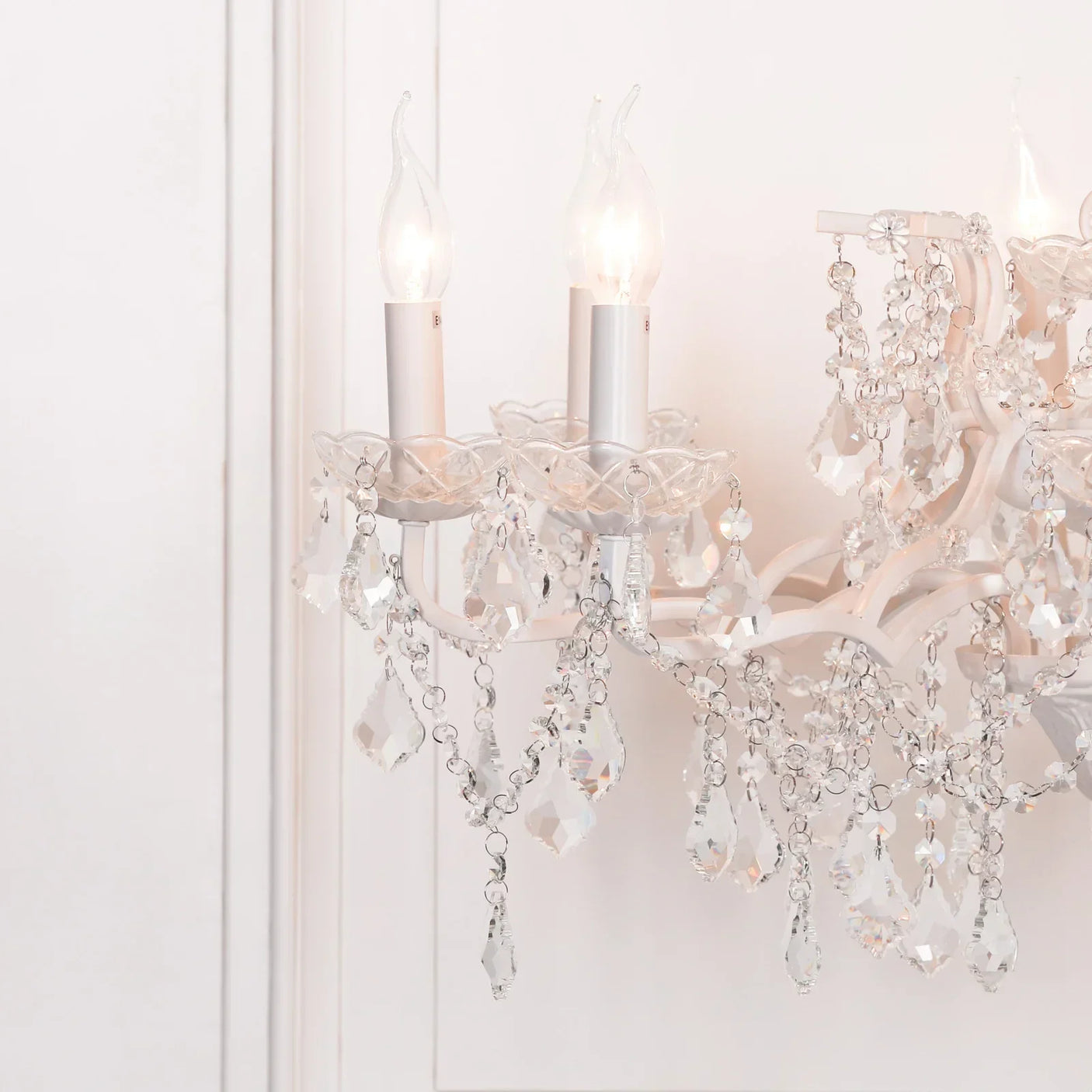Crystal chandelier wall light with candle style bulbs and hanging glass droplets