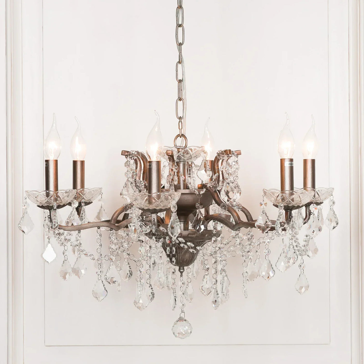 Six light crystal chandelier with bronze arms and hanging glass droplets