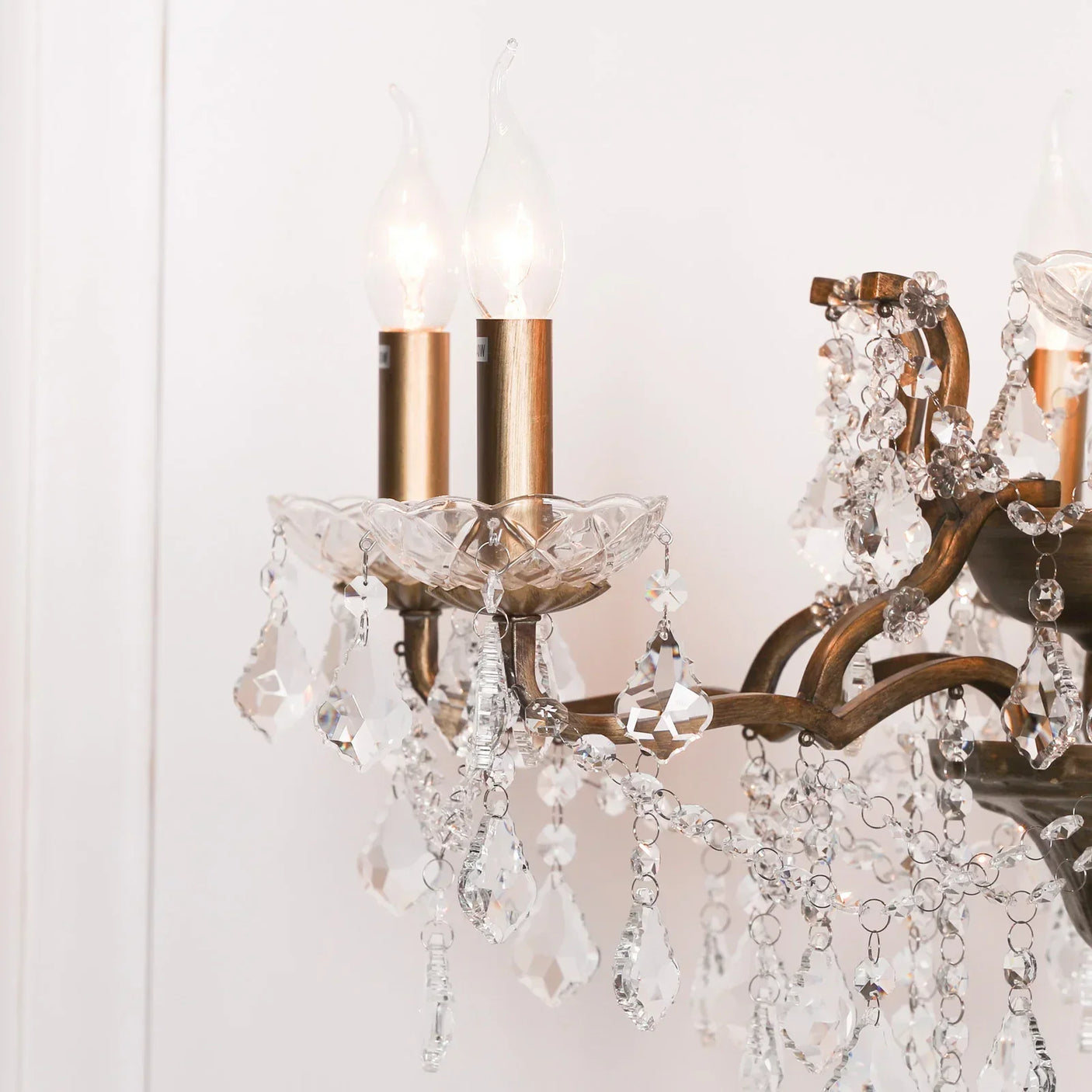 Close-up of crystal chandelier with gold finish and hanging glass pendants