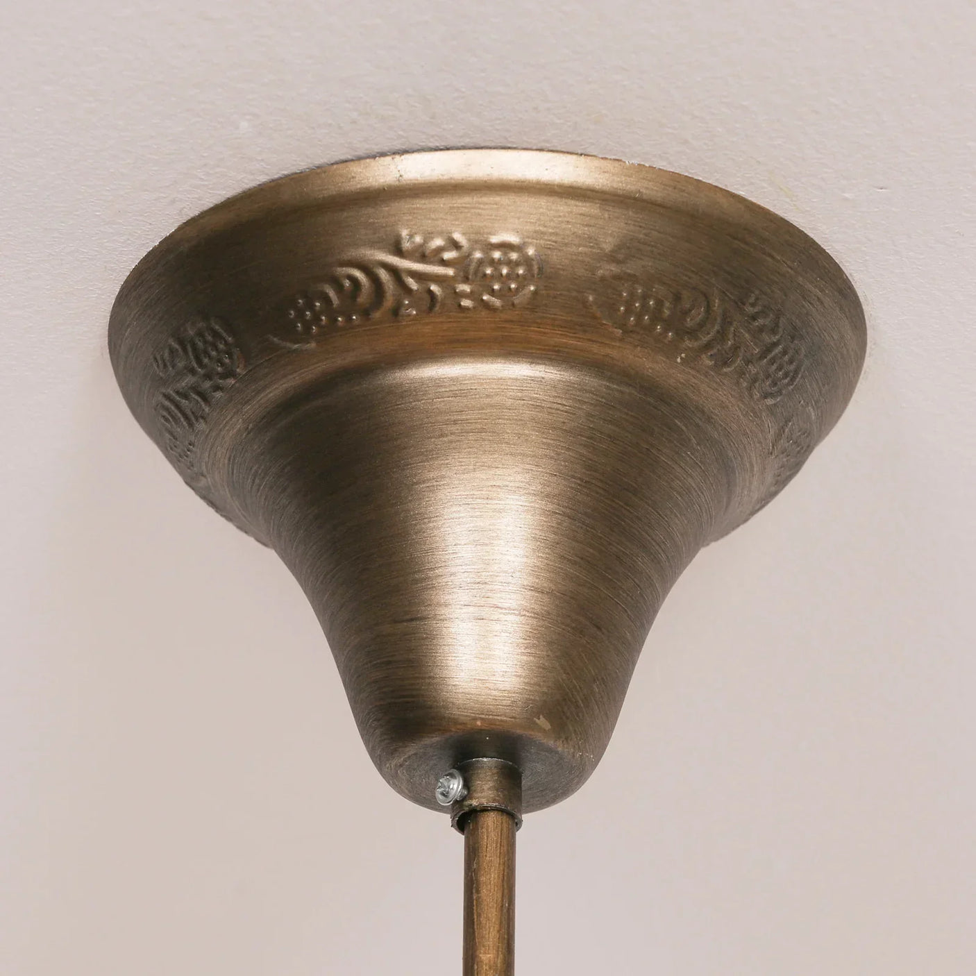 Antique brass ceiling rose with floral detailing for pendant light fixture installation