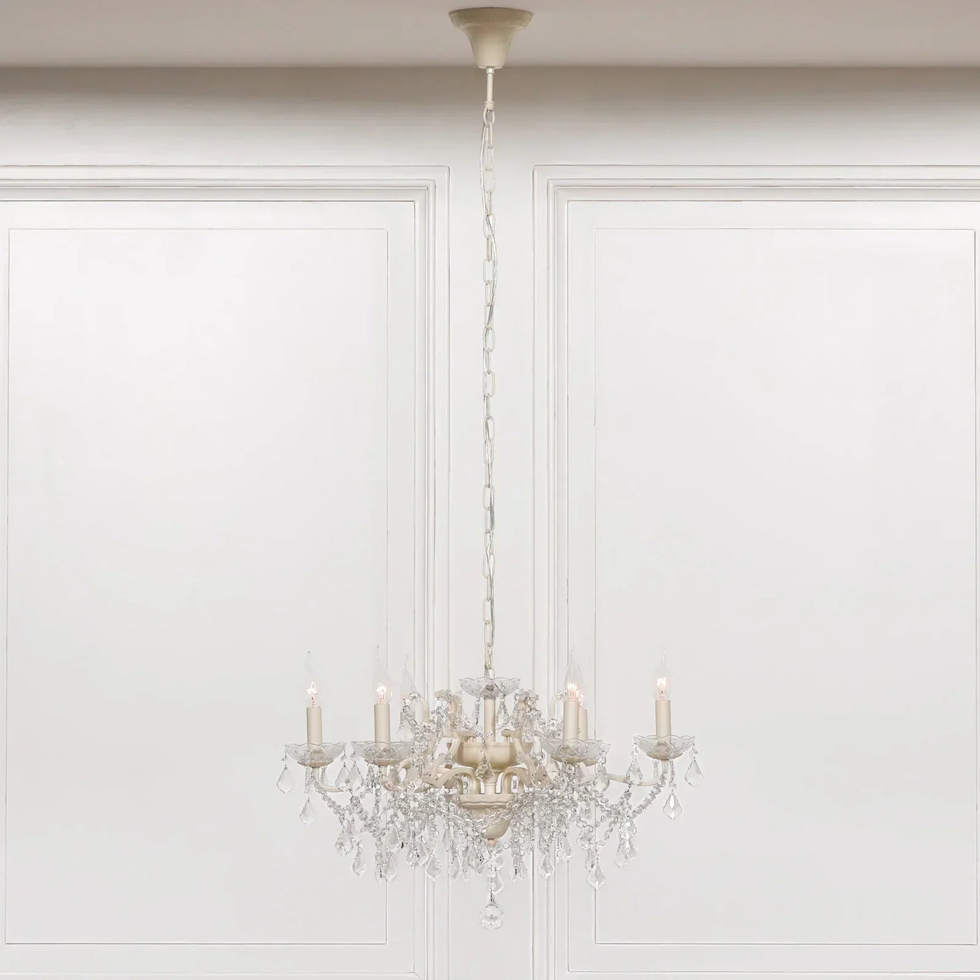 Traditional crystal chandelier with candle lights and hanging glass droplets