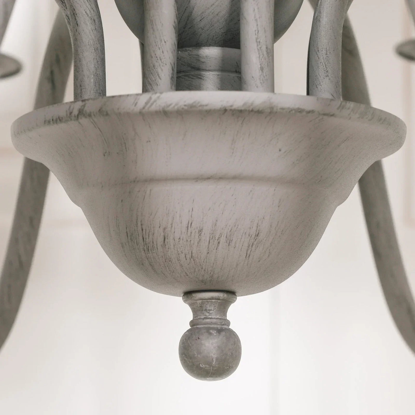 Close detail of grey wooden chandelier base with distressed finish
