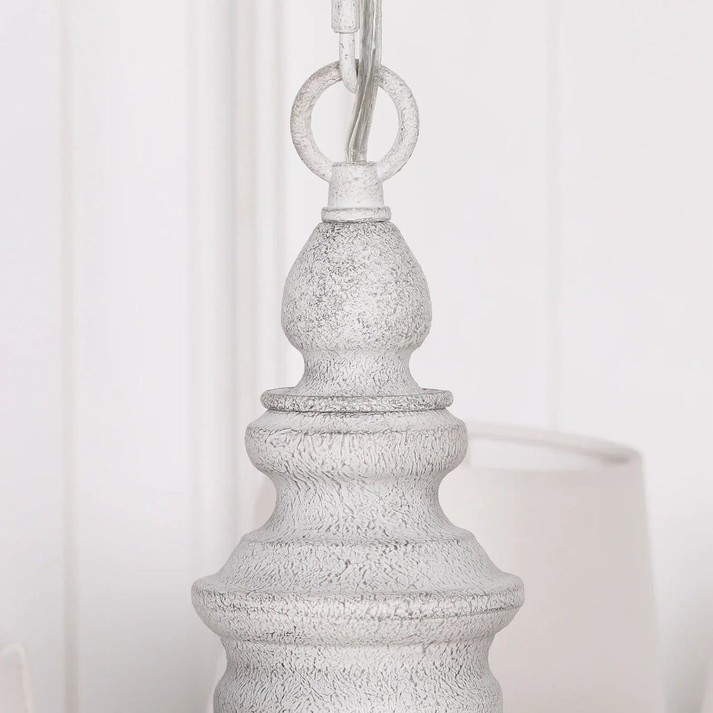 Distressed white wooden lamp finial with textured detailing and silver hanging ring