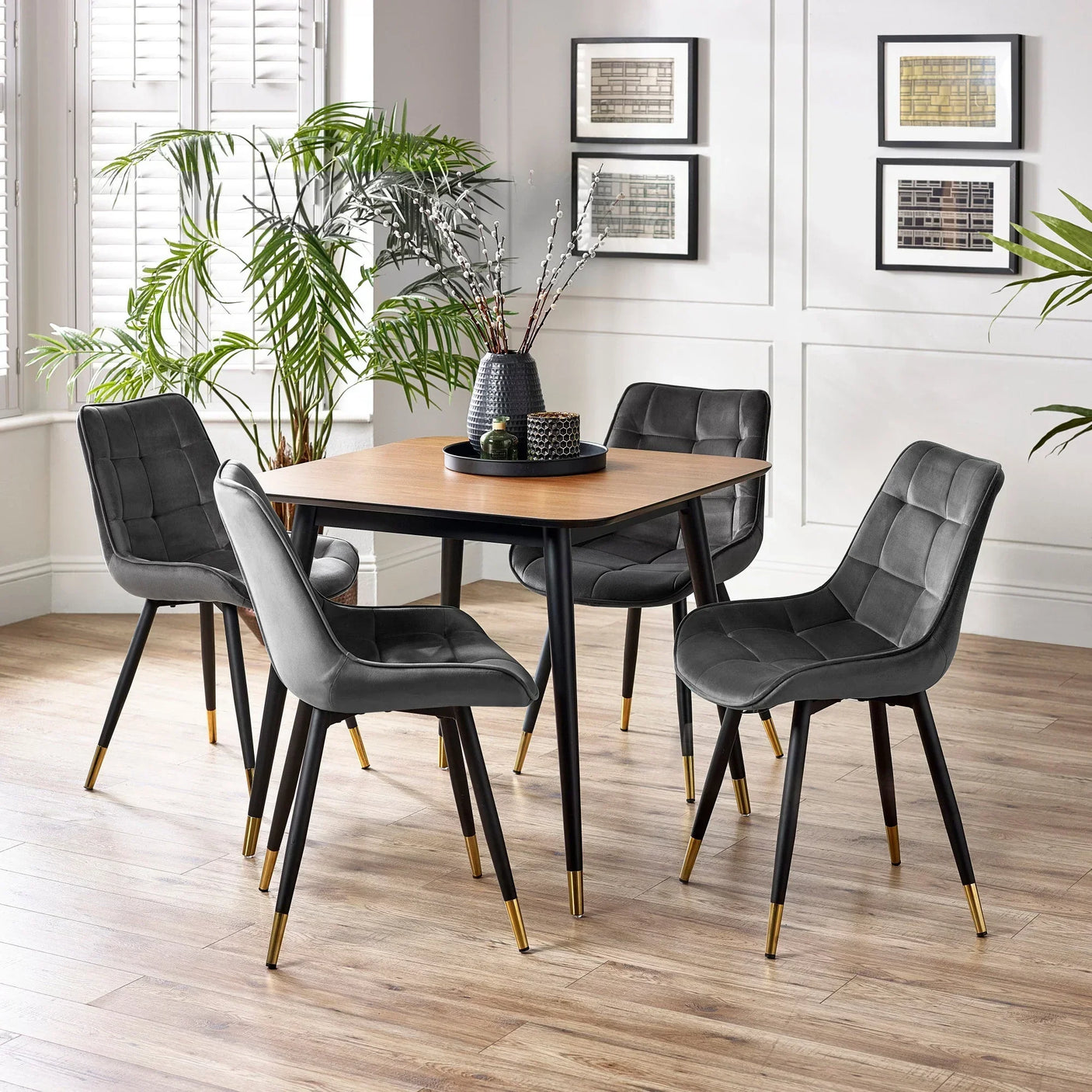 Modern dining set with square wood table and four grey velvet chairs in a bright room