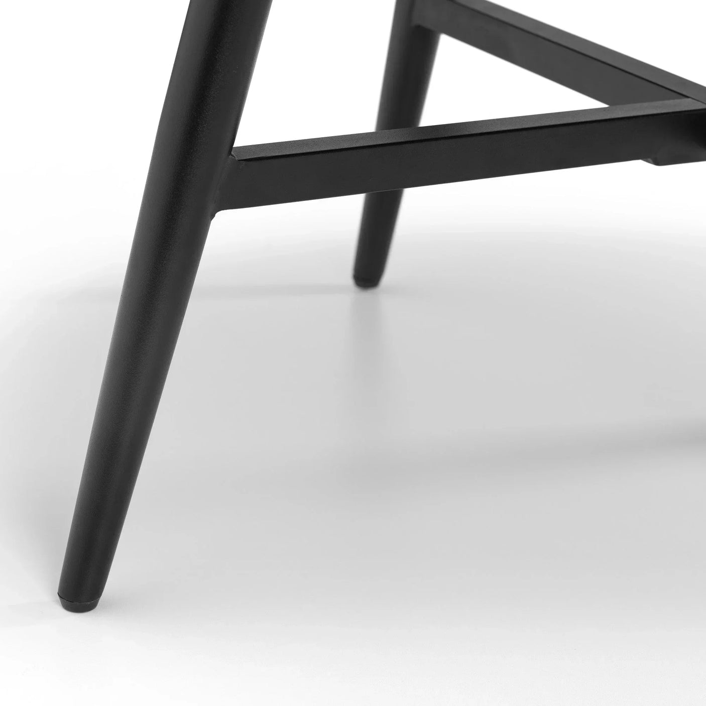 Black metal chair legs with crossbar support on white background