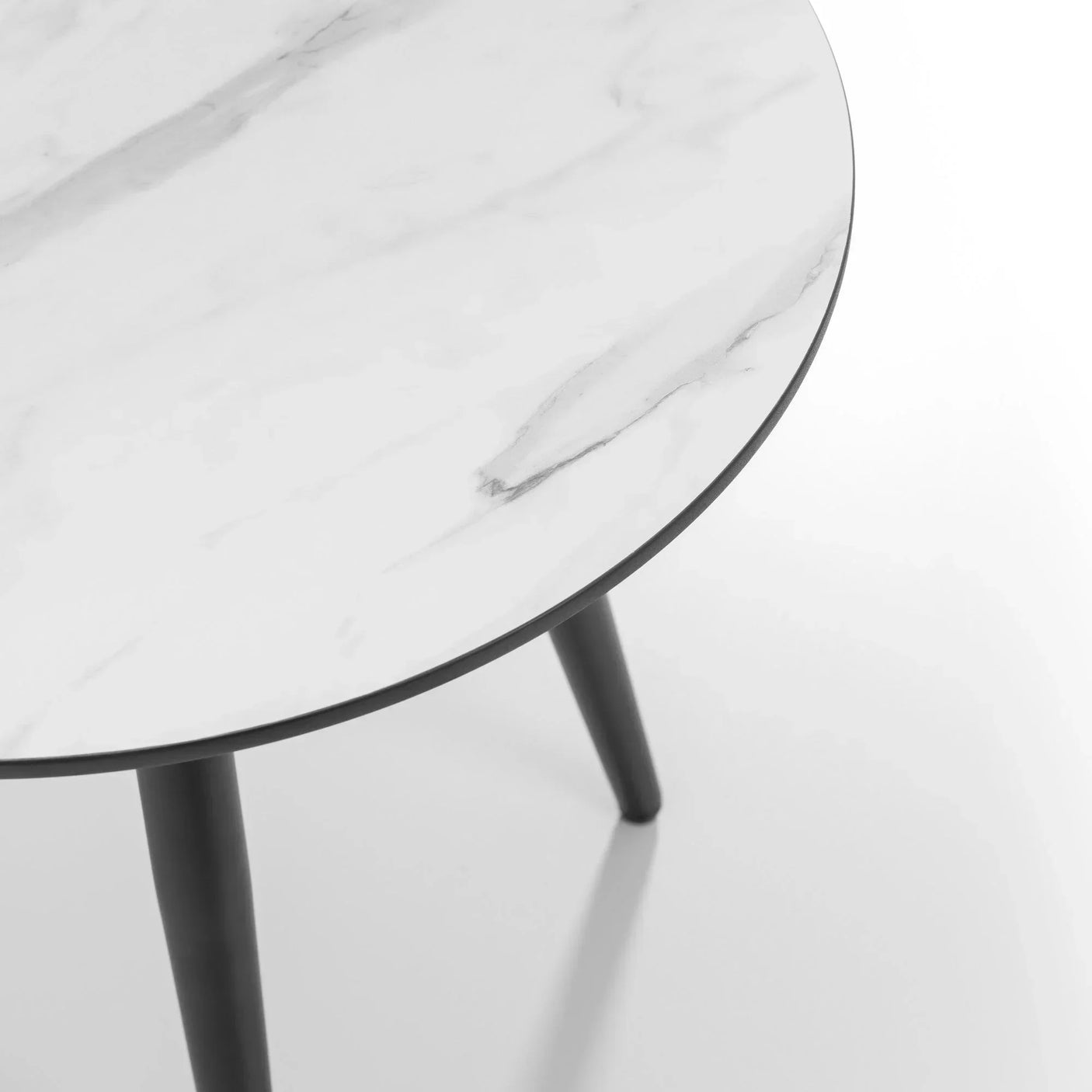 round marble dining table top with black legs close-up