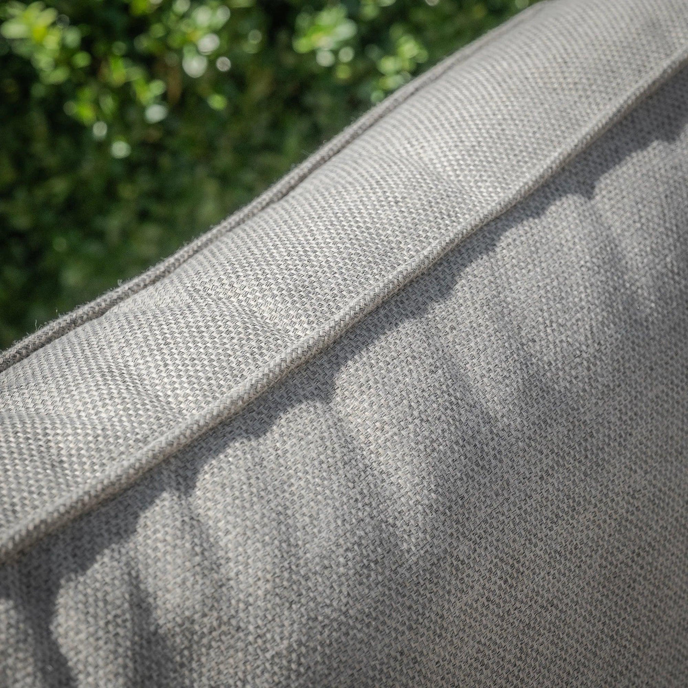 Close-up of grey outdoor sofa cushion fabric and stitching detail