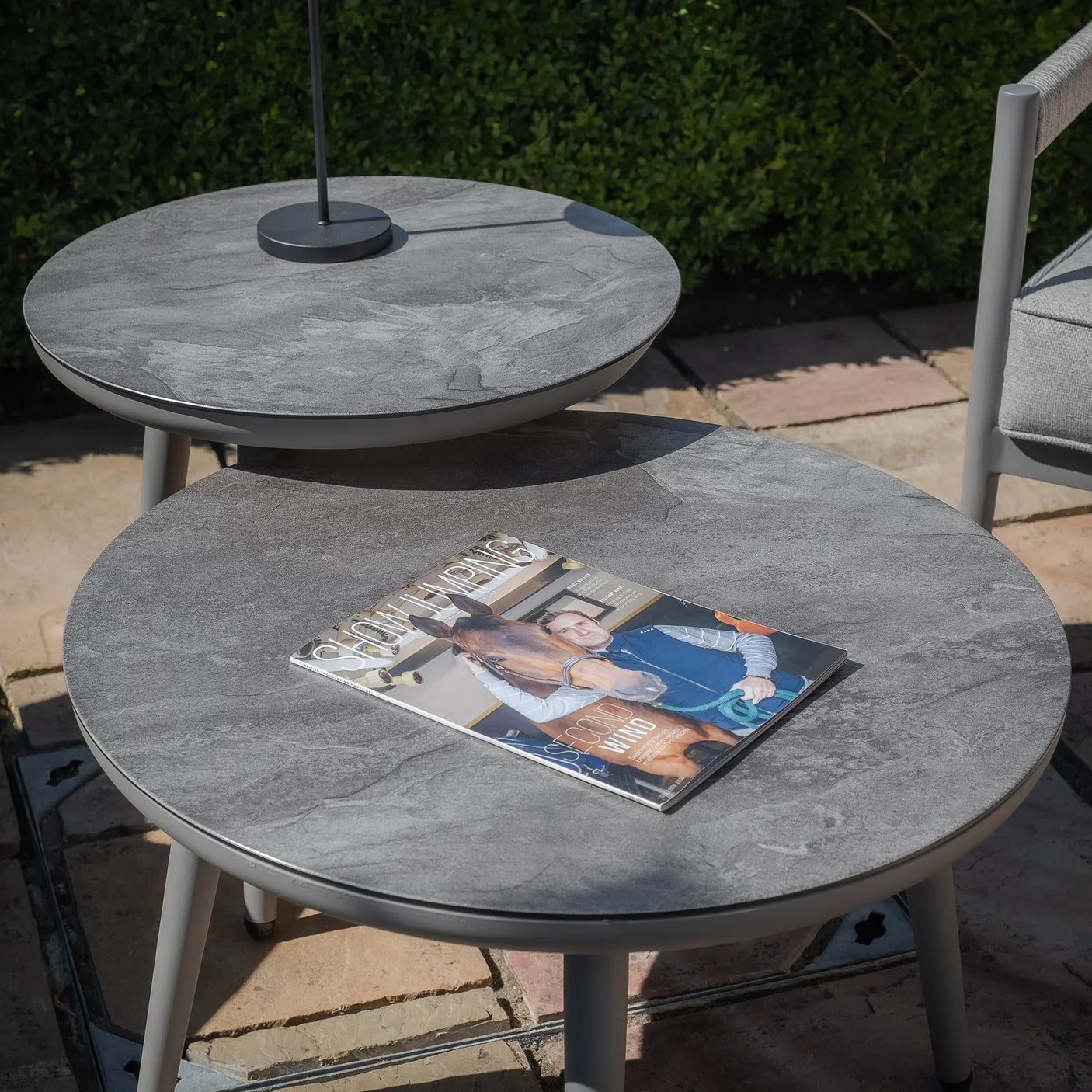 grey stone effect outdoor coffee tables with magazine on patio