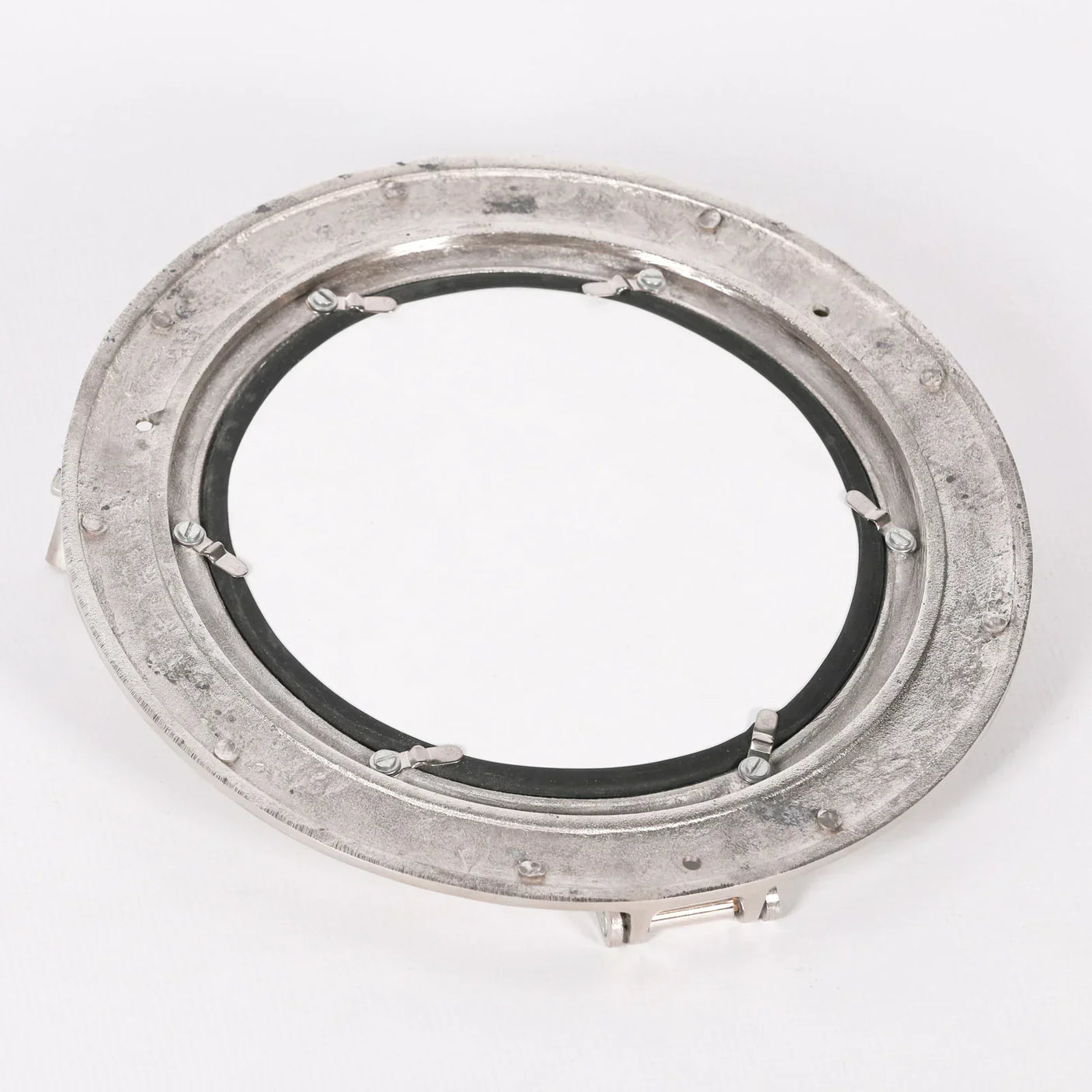 Back view of round porthole mirror with metal frame and visible mounting brackets